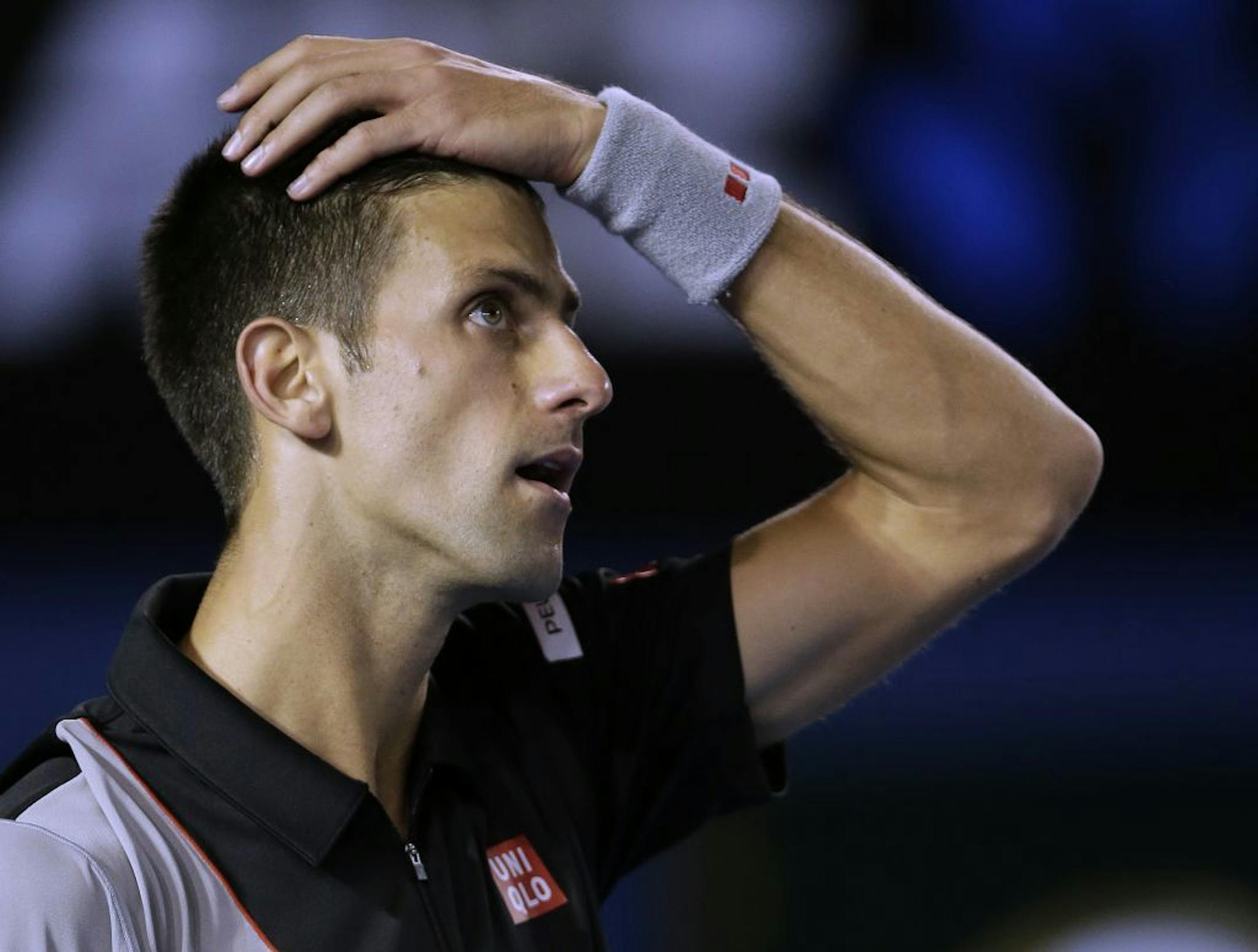 Novak Djokovic of Serbia reacts to a lost point against Stanislas Wawrinka of Switzerland during their quarterfinal at the Australian Open tennis championship in Melbourne, Australia, Tuesday, Jan. 21, 2014.
