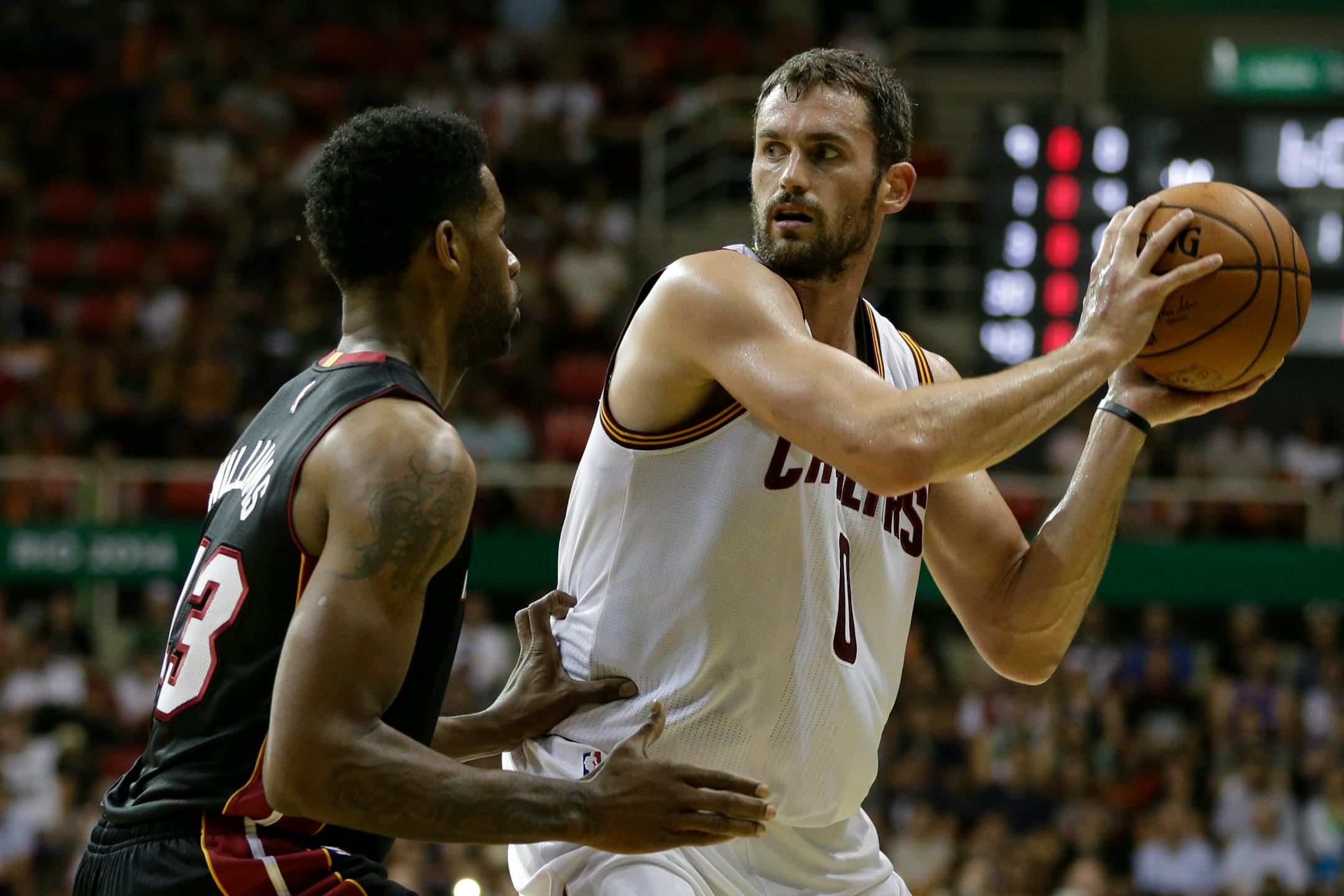 Cleveland Cavaliers' Kevin Love, right, moves the ball under pressure from Miami Heat's Shawne Williams during a NBA preseason basketball game that's part of the NBA Global Games in Rio de Janeiro, Brazil, Saturday, Oct. 11, 2014. (AP Photo/Felipe Dana)