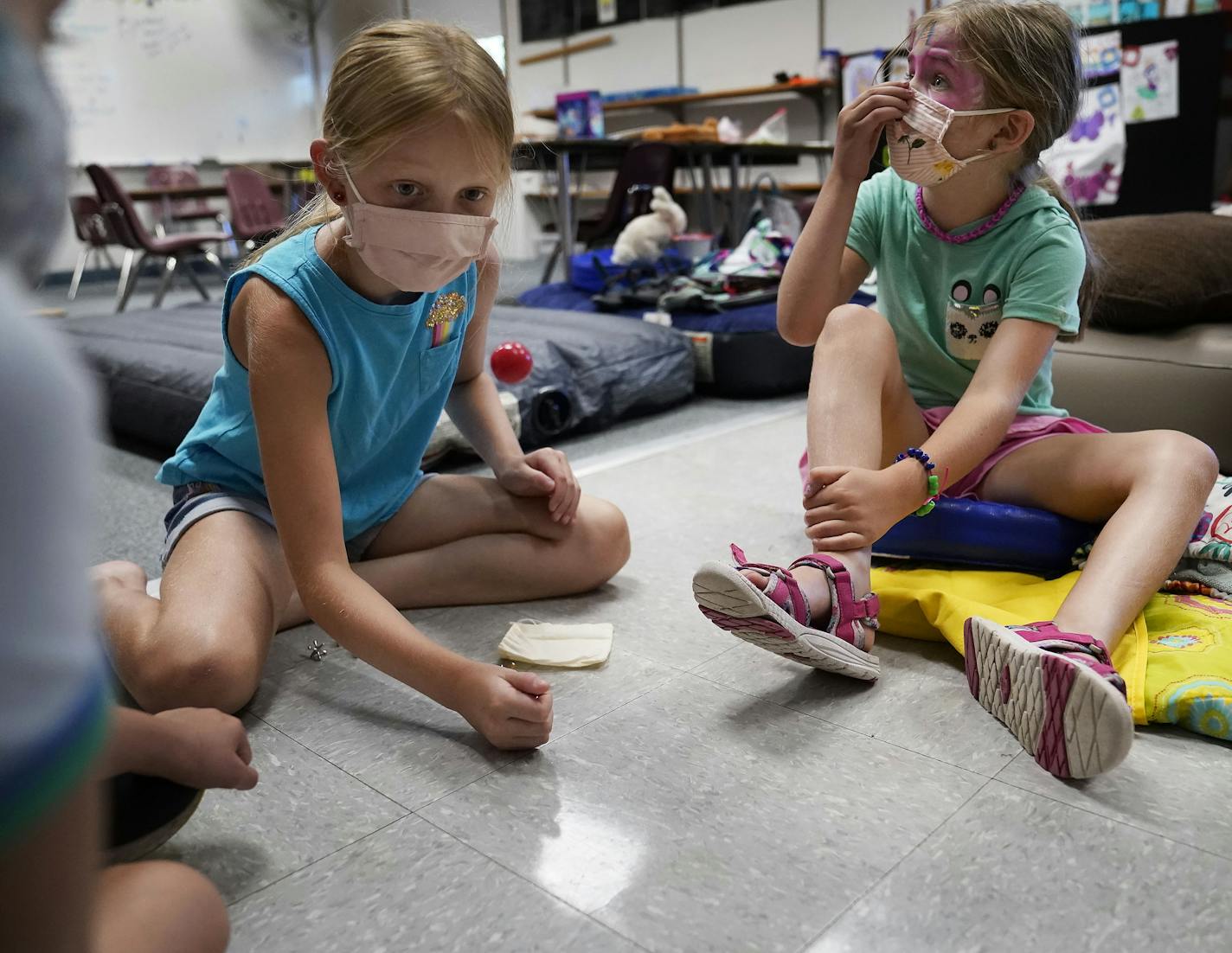 The Discovery Club summer childcare program is in session at Randolph Heights Elementary in St. Paul, where a game of jacks had kids active on Thursday.