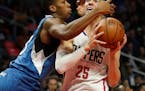 Minnesota Timberwolves guard Kris Dunn, left, defends Los Angeles Clippers guard Austin Rivers during the first half of an NBA basketball game, Thursd
