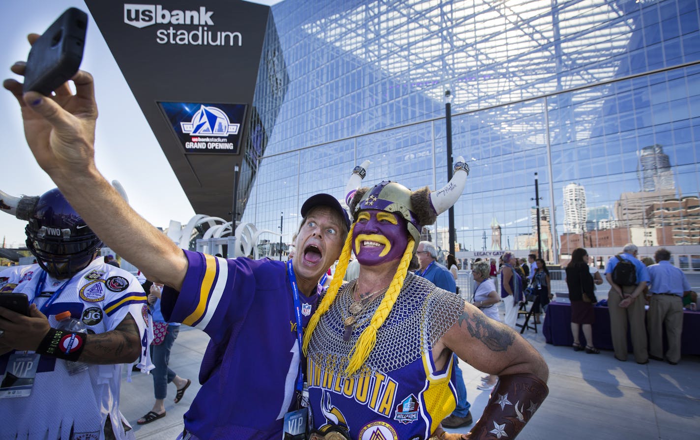 Vikings fans Larry Spooner, of Plymouth, left, and Syd Davy of Vancouver, British Columbia, pose for a photo in front of U.S. Bank Stadium. ] (Leila Navidi/Star Tribune) leila.navidi@startribune.com BACKGROUND INFORMATION: The ceremonial grand opening ribbon cutting for U.S. Bank Stadium in Minneapolis on Friday, July 22, 2016.