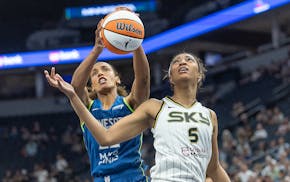 Lynx center Marième Badiane, left, and Sky forward Angel Reese (5) battle for the ball under the net during the first quarter at Target Center on Sat