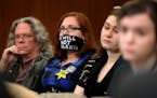 Protestor Amanda Wolfson, second from left, of St. Paul, sent a message without speaking while joining other protestors at a hearing that included dis