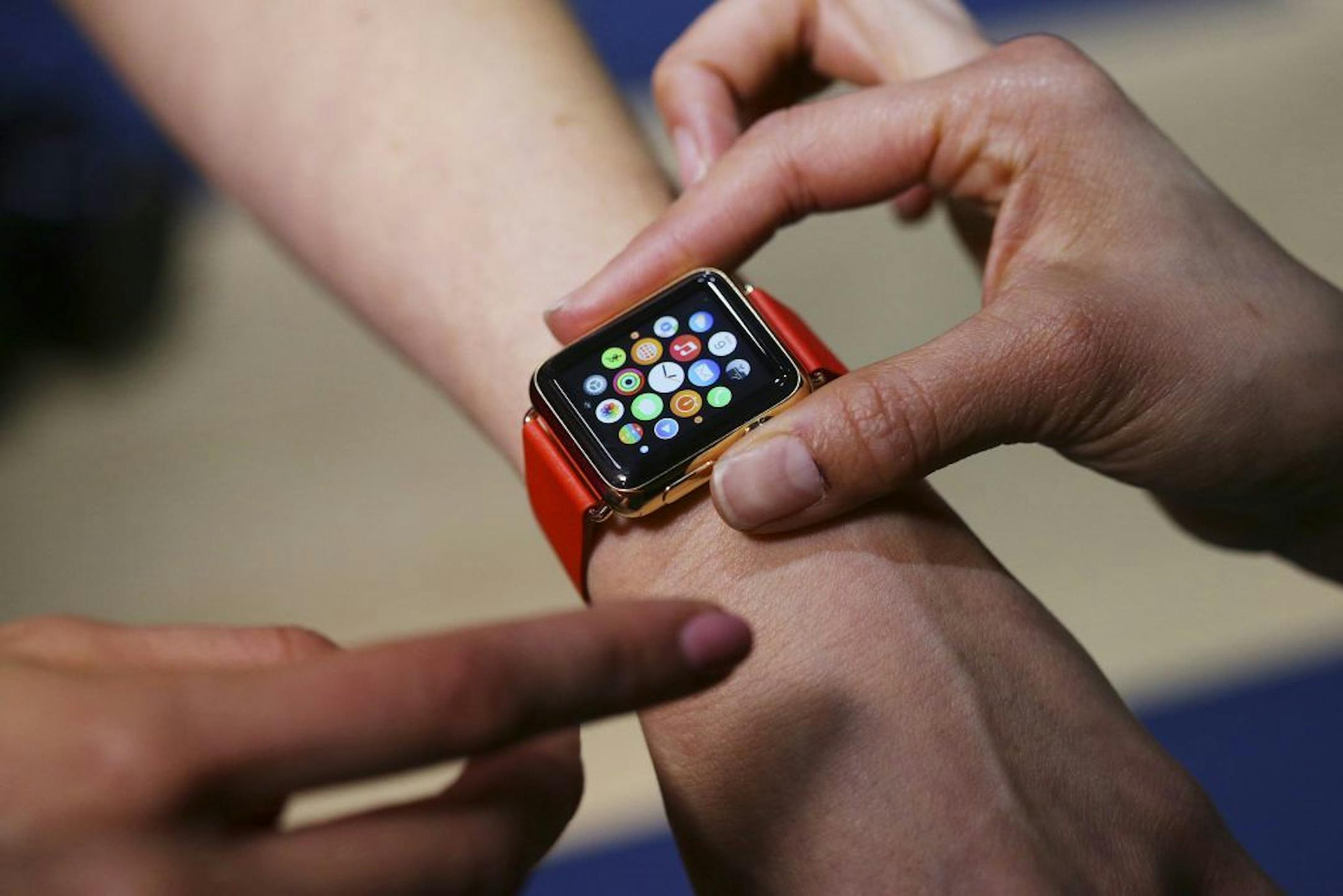 An attendees of Apple's media event tries on the Apple Watch in San Francisco, March 9, 2015. Because a smart watch is both gadget and fashion accessory, Apple designed its device to be highly customizable to suit the tastes of various consumers, from fitness buffs to collectors of luxury watches.