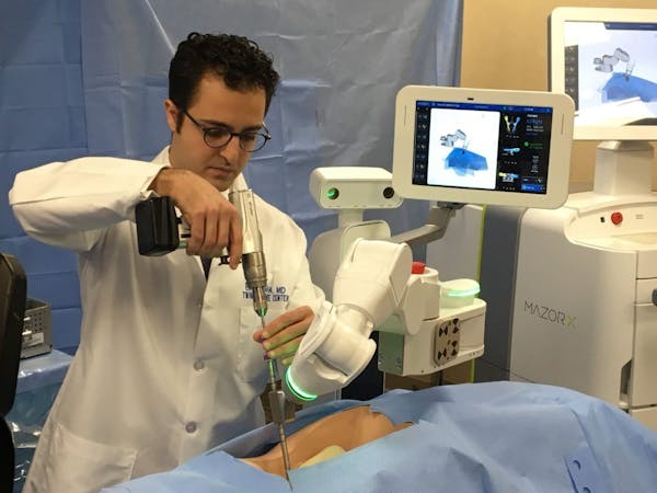 Spine Surgeon Dr. Eiman Shafa of the Twin Cities Spine Center demonstrates the use of Medtronic's Mazor X robotically navigated spine-surgery system T