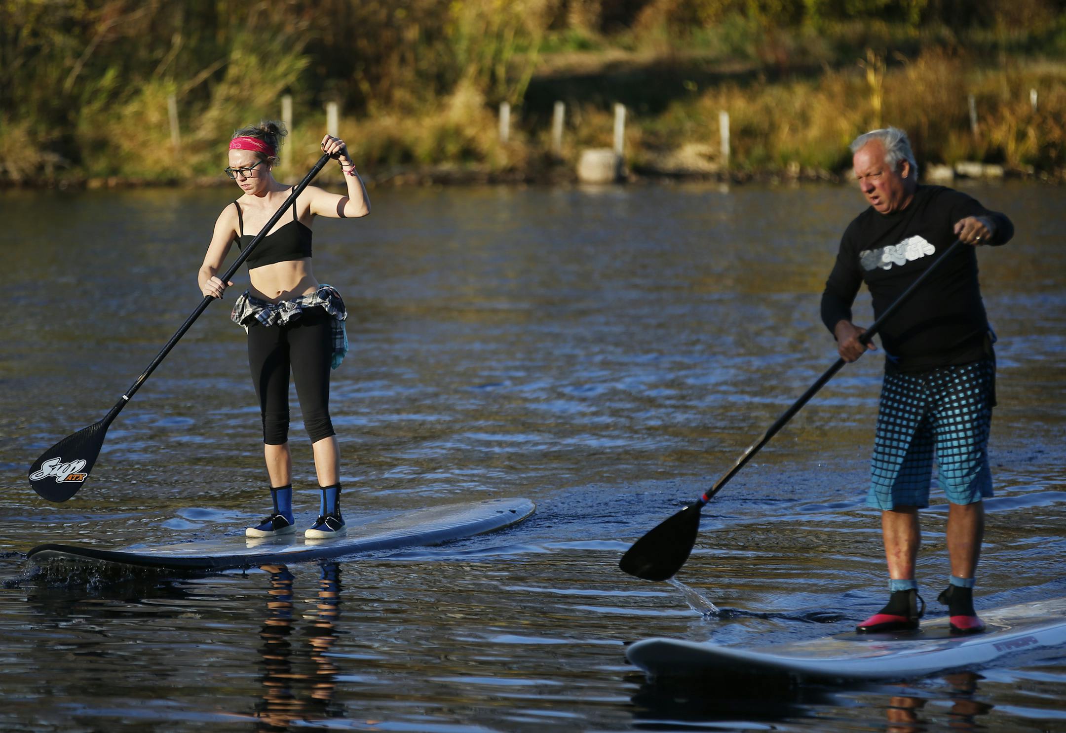 On Lake Calhoun, Cassandra Brink and Bill Brink enjoyed the unseasonably warm weather by doing some stand up paddling.]Richard Tsong-Taatarii/rtsong-taatarii@startribune.com