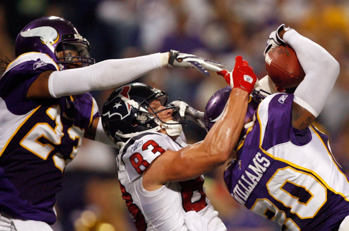 MINNEAPOLIS - NOVEMBER 02: Kevin Walter #83 of the Houston Texans has a pass intercepted by Madieu Williams #20 of the Minnesota Vikings with Cedric Griffin #23 during the third quarter at the Hubert H. Humphrey Metrodome on November 2, 2008 in Minneapolis, Minnesota. The Vikings won 28-21.