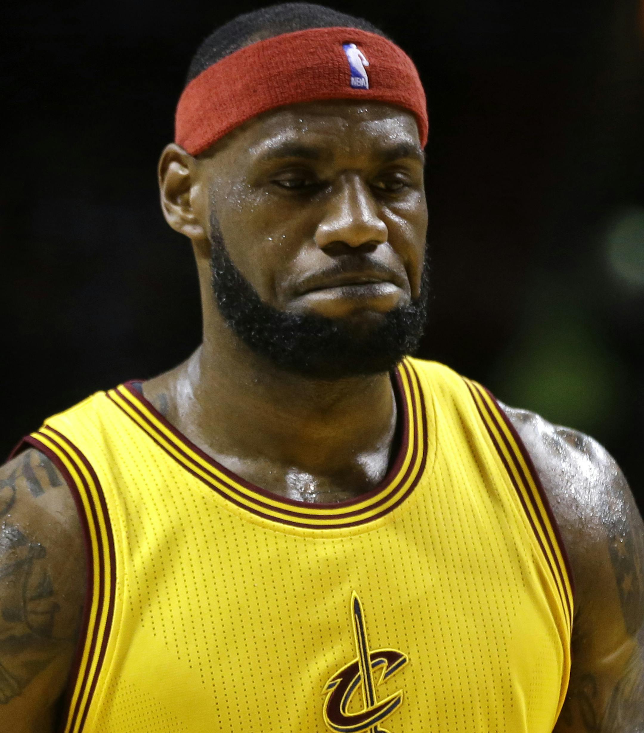 Cleveland Cavaliers forward LeBron James (23) walks on the court during the first half of an NBA basketball game against the Miami Heat, Thursday, Dec. 25, 2014, in Miami. (AP Photo/Lynne Sladky)