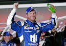 Dale Earnhardt Jr celebrates in Victory Lane after winning the first of two qualifying races for the Daytona 500 NASCAR Sprint Cup series auto race at