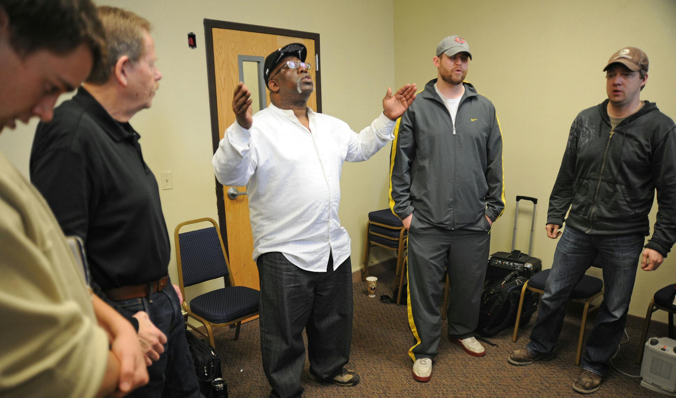 Three people died and five were injured Sunday when their minivan overturned on a busy segment of Interstate 94 in north Minneapolis, closing off a portion of the highway for much of the afternoon. Reggie Hannah a pastor of the New Wine Church in Minneapolis said a prayer for the family members killed in the crash, during a prayer meeting in the basement of the church. ] Richard.Sennott@startribune.com Richard Sennott/Star Tribune. , Minneapolis, Minn. Monday 4/8/13) ** (cq)