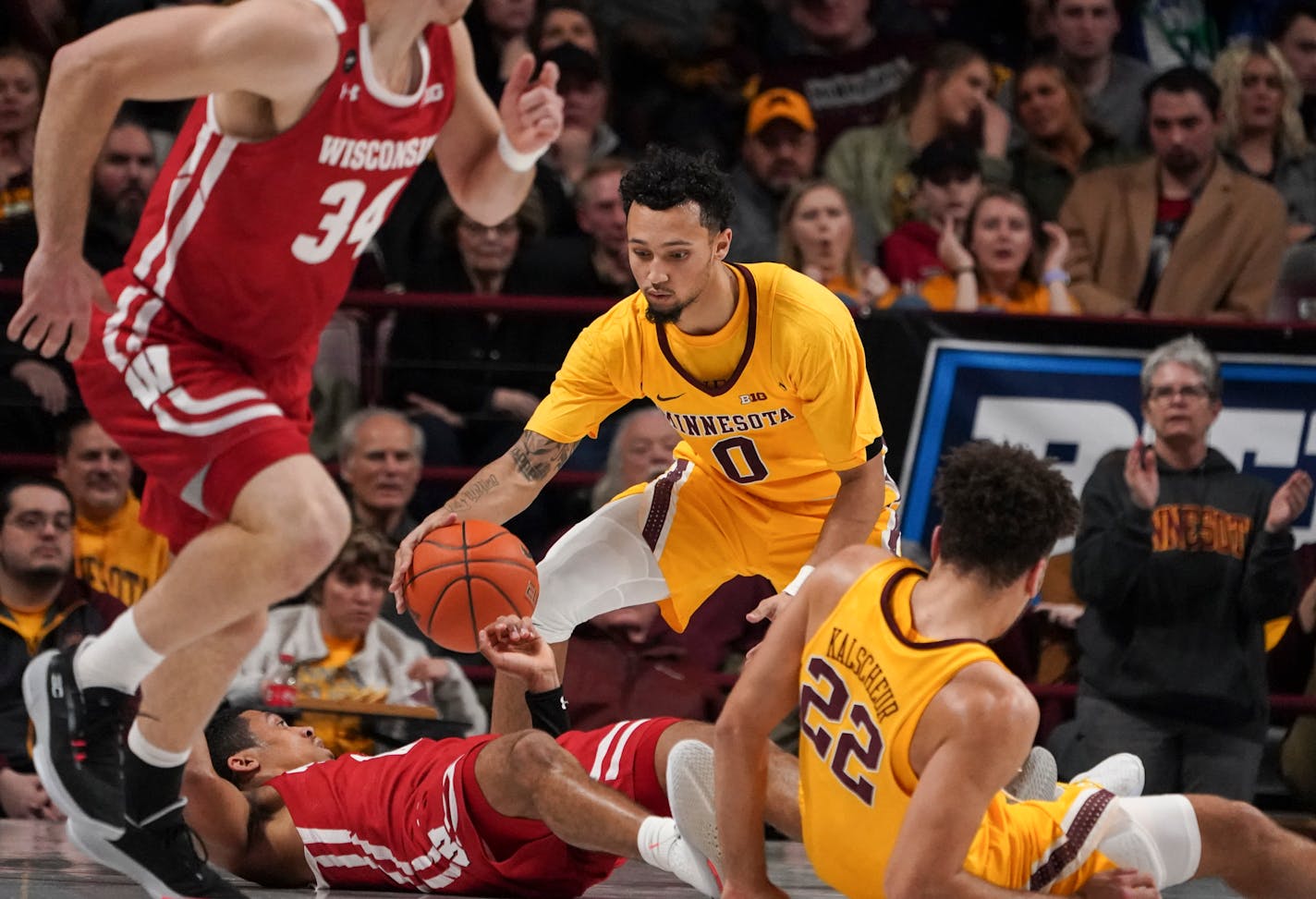 Gophers guard Payton Willis grabbed a loose ball after Wisconsin guard D'Mitrik Trice tripped and lost it in the first half.