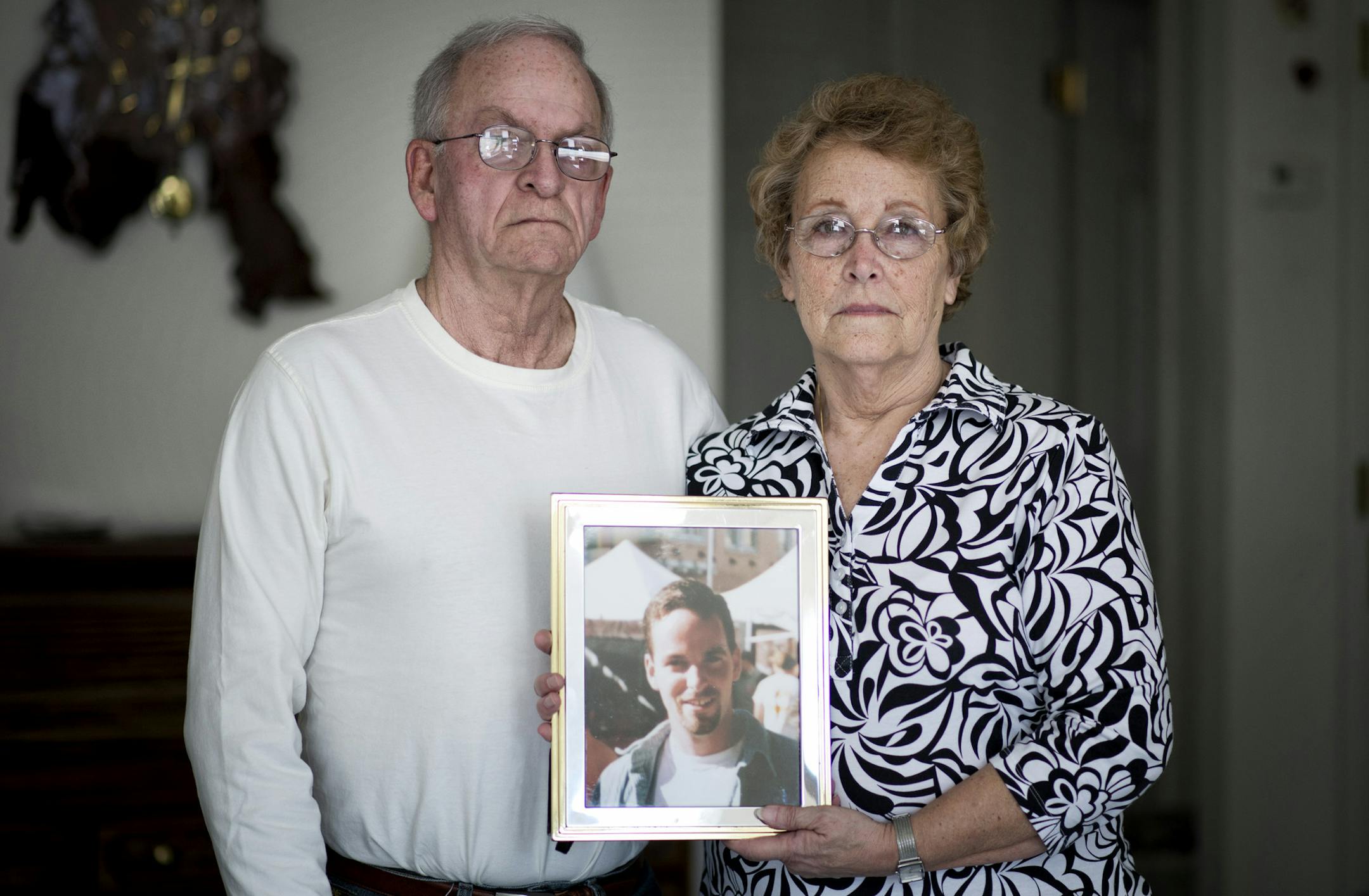 Wini and Harley Kester hold a photo of Kyle, who had settled in Mexico and made friends with the locals — three of whom are suspected of killing him on Feb. 10.