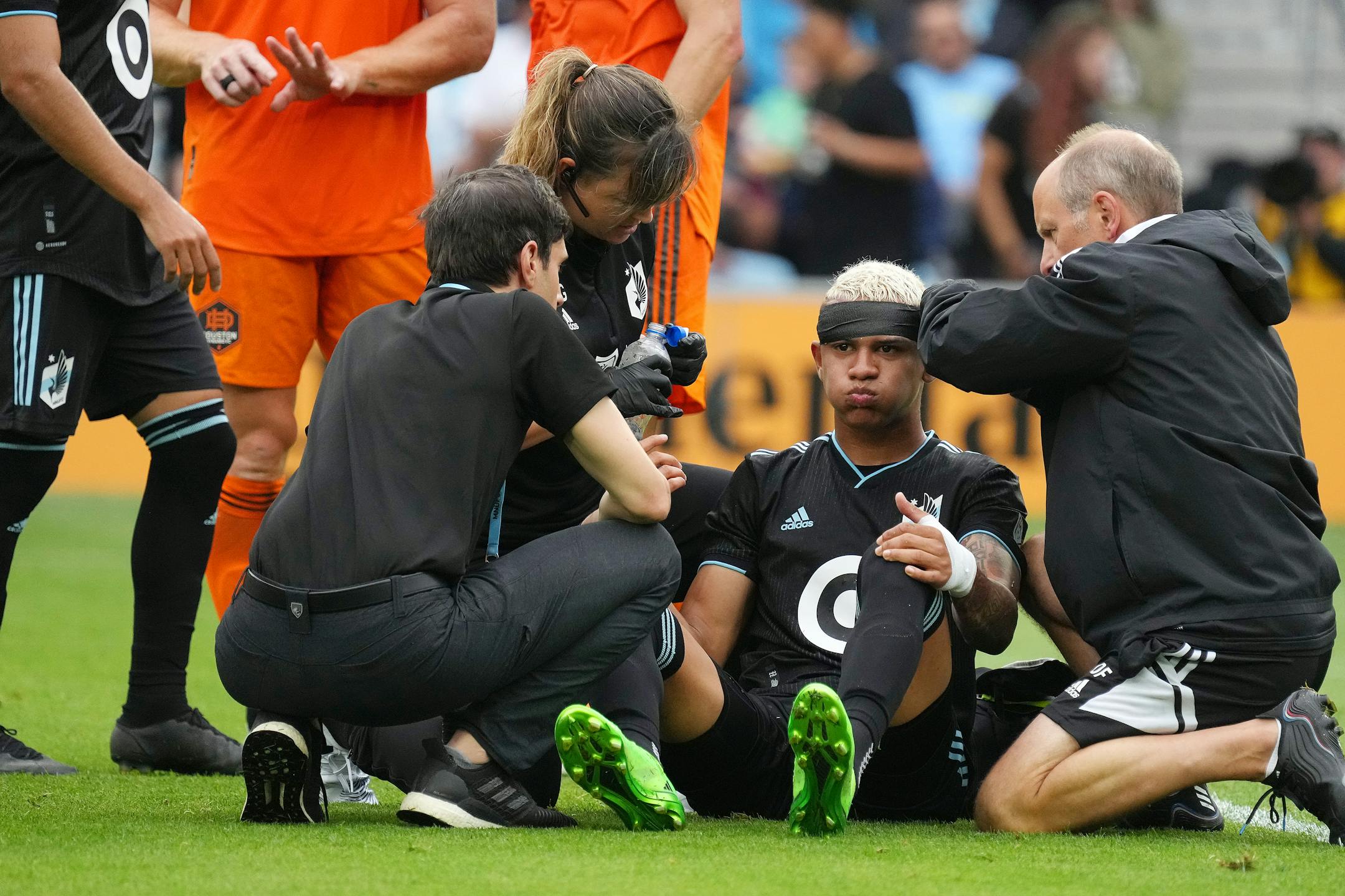 Minnesota United midfielder Kervin Arriaga (33) sits up after having his head bandaged from an injury trying to head a corner kick in the first half of an MLS game between Minnesota United and the Houston Dynamo.