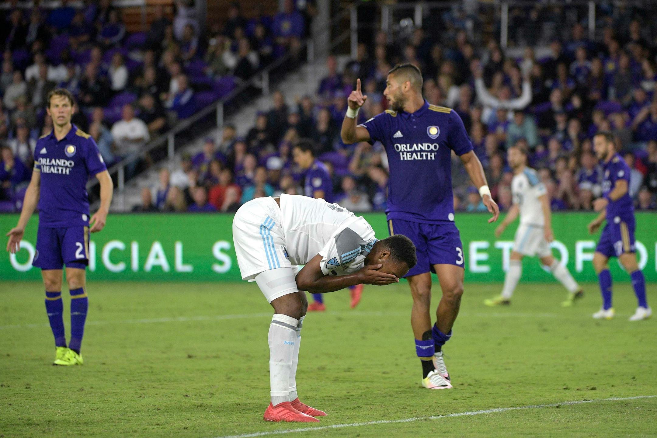 Minnesota United forward Mason Toye reacts after missing a shot on goal in front of Orlando City defender Amro Tarek during the second half of an MLS soccer match Saturday, March 10, 2018, in Orlando, Fla. Minnesota won 2-1. (Phelan M. Ebenhack for the Star-Tribune) ORG XMIT: OTKMINN109