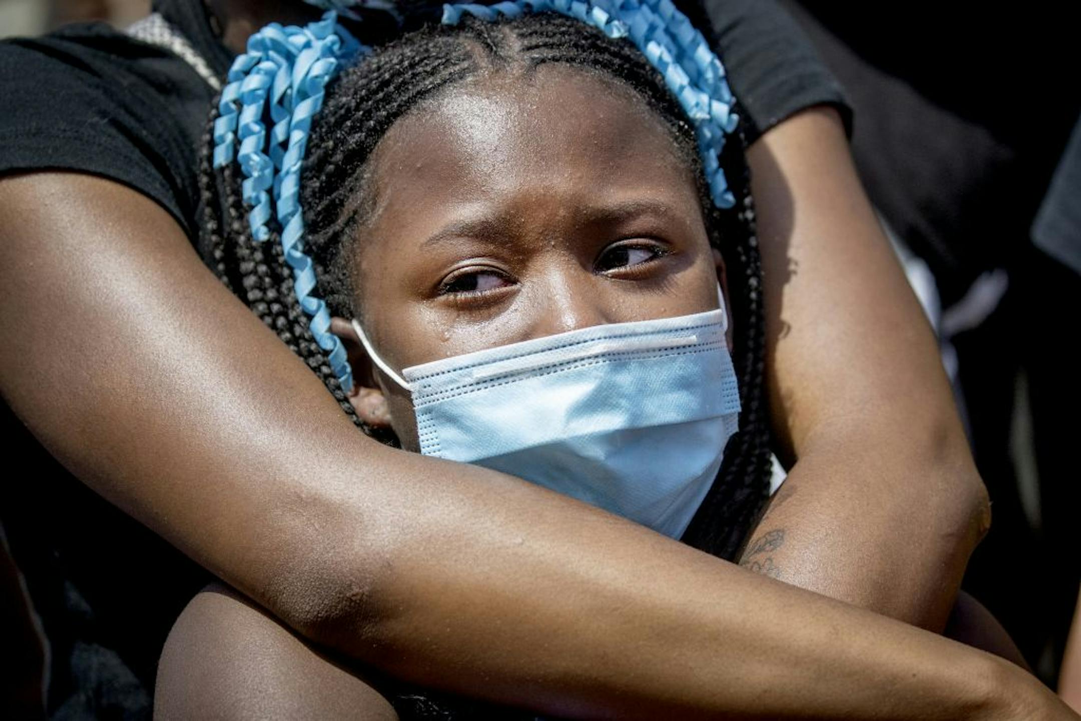 Sentira Lee held her daughter Zemirah Lee, 9, as she became emotional as they prayed at the corner where George Floyd was killed by a Minneapolis police officer at Chicago and 38th Street, Sunday, May 31, 2020 in Minneapolis.