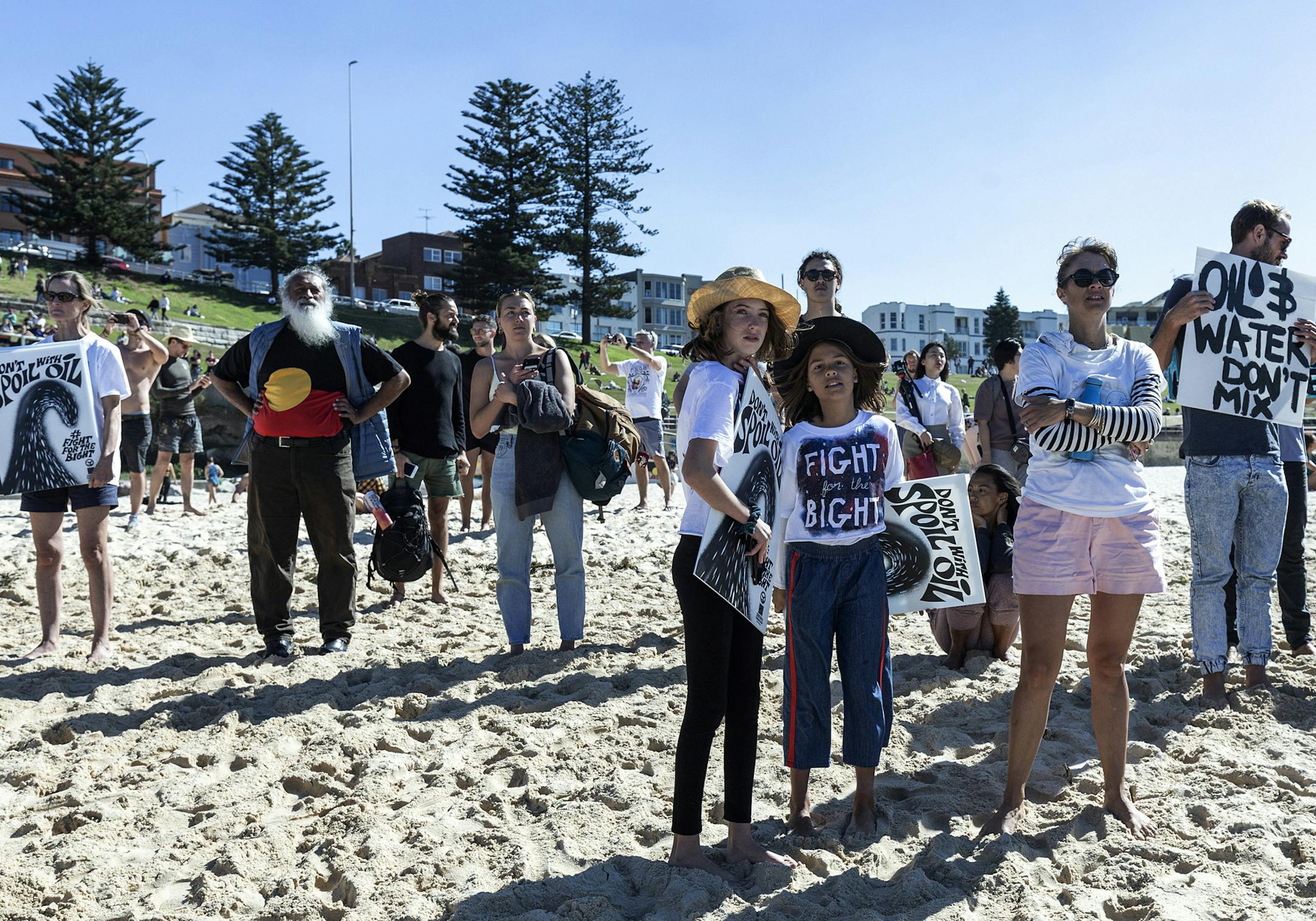 A crowd watches as surfers paddle out into the water at Bondi Beach in Sydney, Australia, in protest against oil and gas drilling in the Great Australian Bight, on April 28, 2019. With federal elections set for next month, the proposal to drill for oil and natural gas in the Bight is now taking center stage, with beaches as political forum. (Anna Maria Antoinette D’Addario/The New York Times)