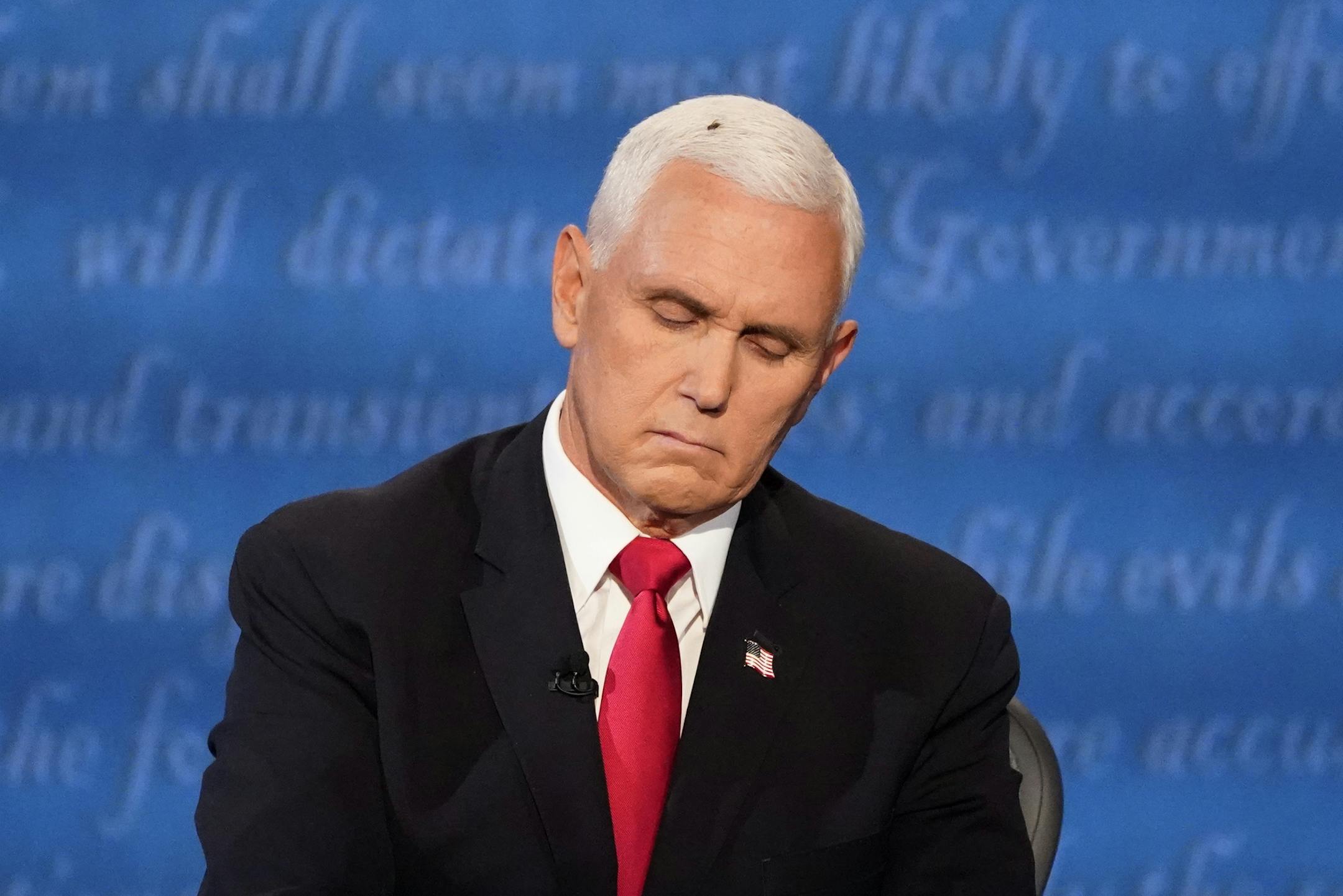Vice President Mike Pence listens to Democratic vice presidential candidate Sen. Kamala Harris, D-Calif., during the vice presidential debate Wednesday, Oct. 7, 2020, at Kingsbury Hall on the campus of the University of Utah in Salt Lake City. (AP Photo/Julio Cortez)