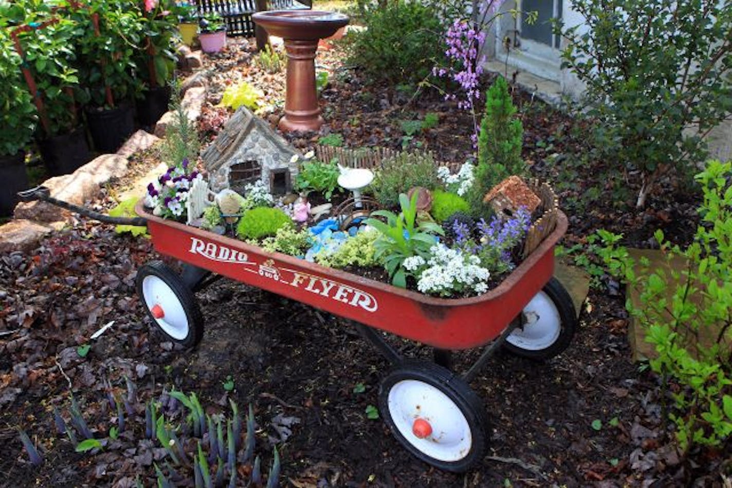 A red radio flyer wagon can be repurposed for the garden.