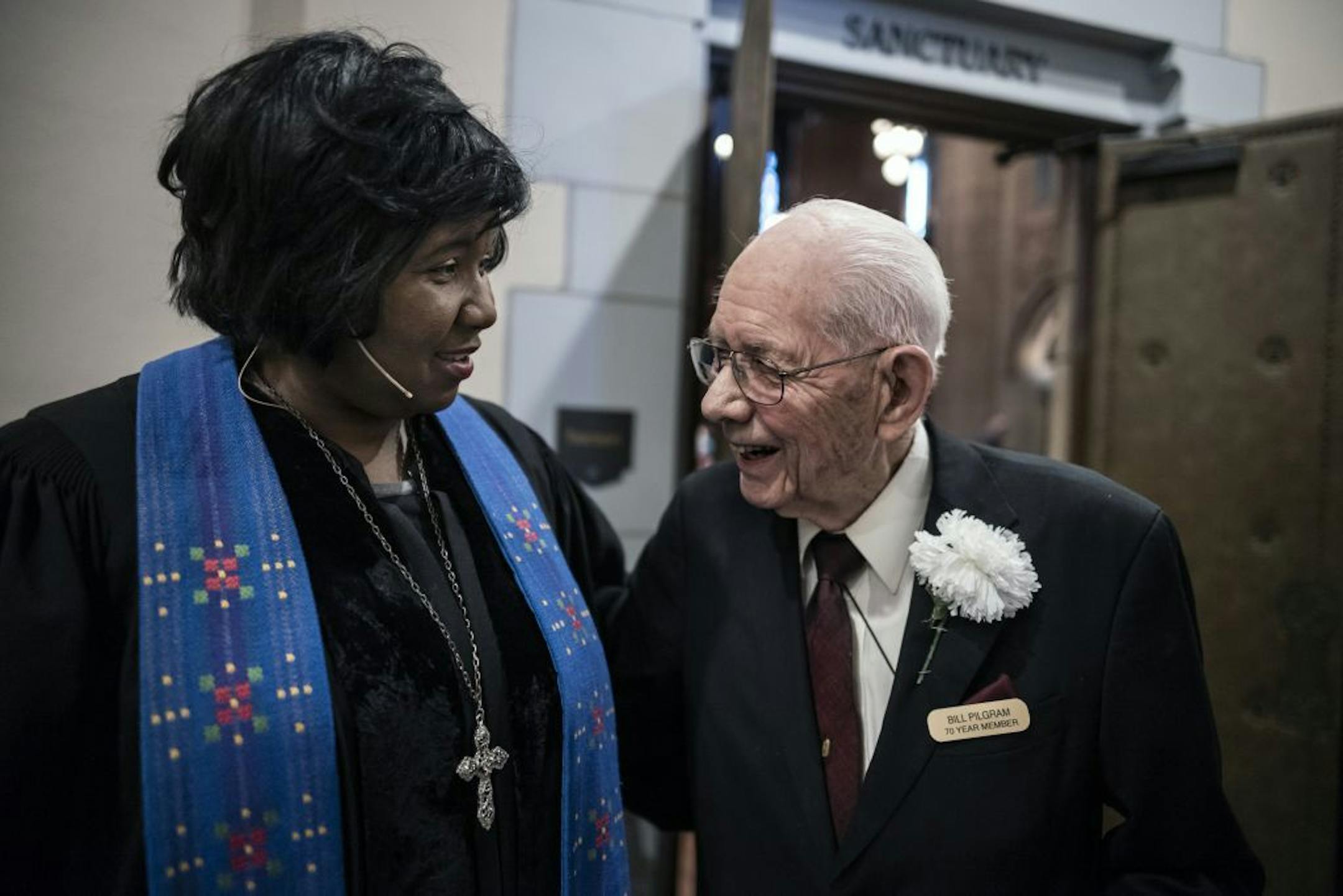 At Sunday service, Bill Pilgram greets pastor Frenchye McGee. Hennepin United Methodist Church was one of the first to integrate in the 1950's. Pilgram truly takes great pleasure in meet his fellow parishioners on Sunday. He has also put in countless hours on various maintenance projects at this church.