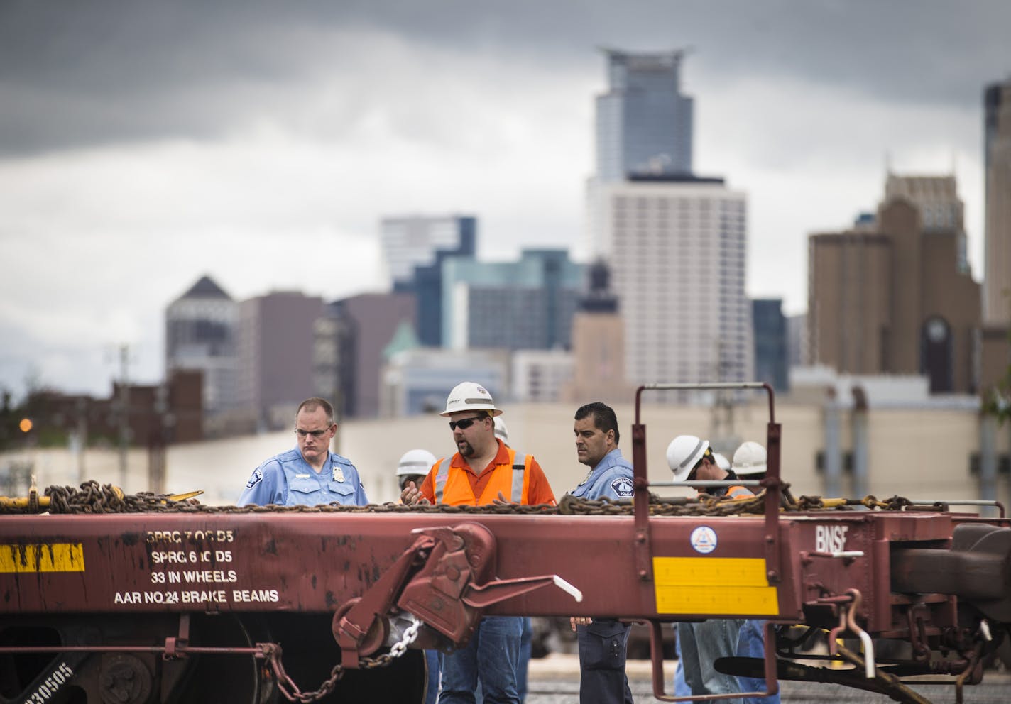 A rail worker spoke to officers at the scene of a fatal incident involving a train at BNSF Railway on Harrison St. in Minneapolis, Minn. on Monday, May 25, 2015. ] RENEE JONES SCHNEIDER &#x2022; reneejones@startribune.com