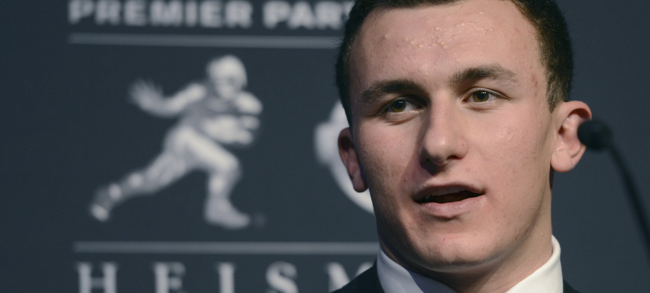 FILE - In this Dec. 8, 2012 file photo, Texas A&M quarterback Johnny Manziel speaks during a news conference prior to the announcement of the Heisman trophy winner in New York. Manziel has pleaded guilty to a misdemeanor charge stemming from his arrest last year for fighting outside a bar near campus. The Heisman Trophy winner made a brief appearance in court Monday, July 15, 2013 in College Station, Texas, and admitted he failed to identify himself to police following the altercation in June 20