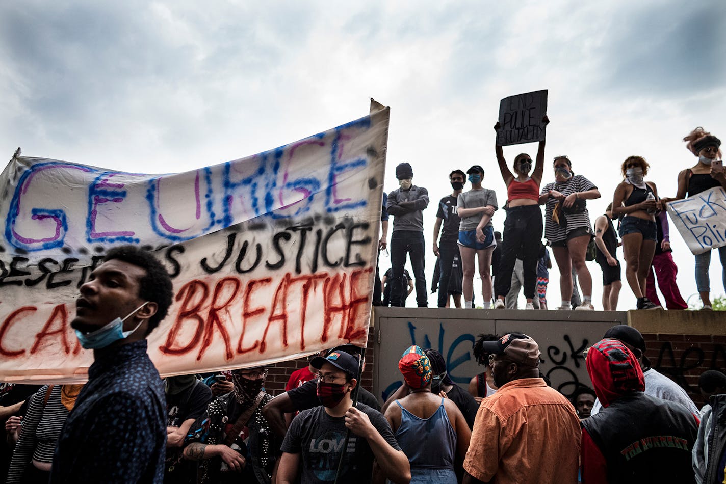 People near a clash between protestors and police at the Minneapolis 3rd Police Precinct after people gathered at Chicago Ave. and East 38th Street during a rally for George Floyd in Minneapolis on Tuesday, May 26, 2020. Federal authorities are investigating a white Minneapolis police officer for possible civil rights violations, after a video surface showing him kneeling on a handcuffed African-American man�s neck and ignoring the man�s protests that he couldn�t breathe.