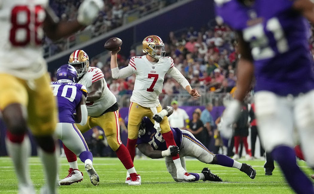 San Francisco quarterback Nate Sudfeld throws under pressure from Vikings defensive tackle T.Y. McGill in the third quarter Saturday.