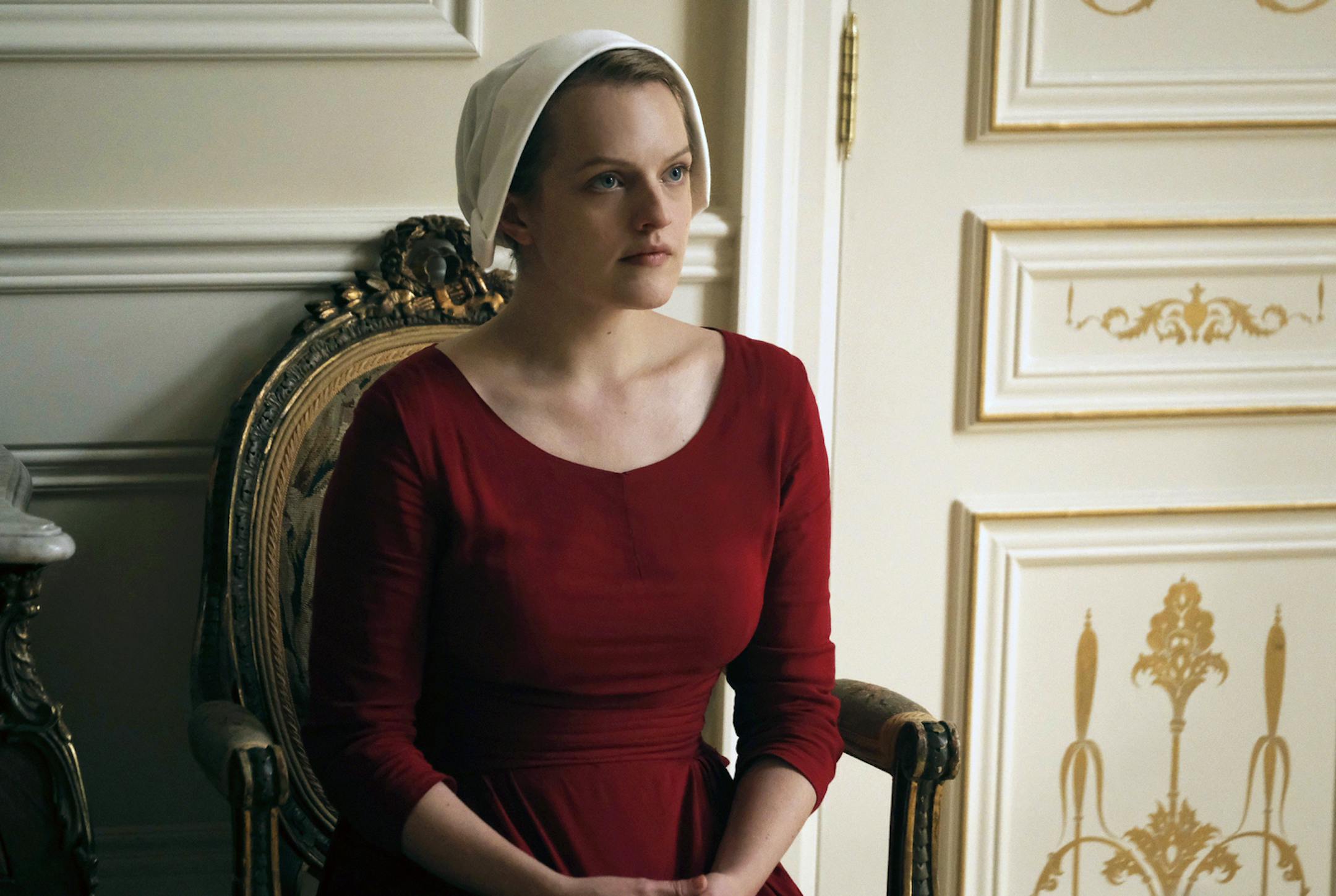 This image released by Hulu shows Elisabeth Moss as Offred in a scene from, "The Handmaid's Tale," premiering Wednesday on Hulu with three episodes. The remaining seven hours will be released each Wednesday thereafter. (George Kraychyk/Hulu via AP) ORG XMIT: MIN2017042611200311