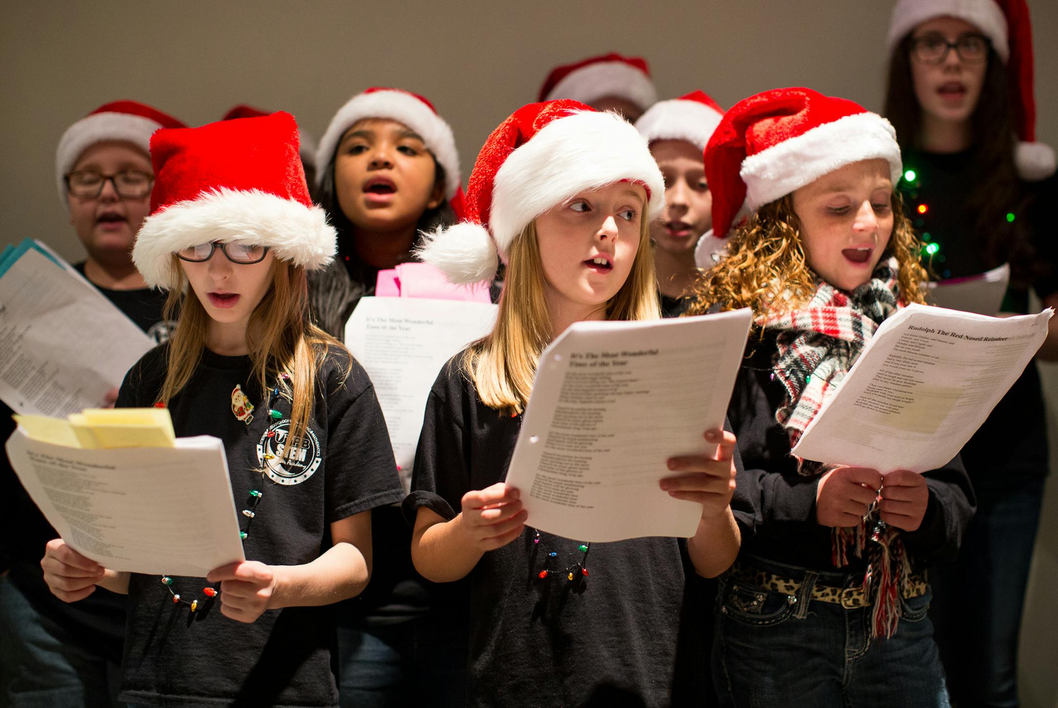 Members of the UTPB STEM Academy's student council sing Christmas carols at the Ellen Noel Art Museum's Holiday Open House and Toy Drive in Odessa, Texas on Tuesday, Dec. 9, 2014. (AP Photo/The Odessa American, Courtney Sacco)