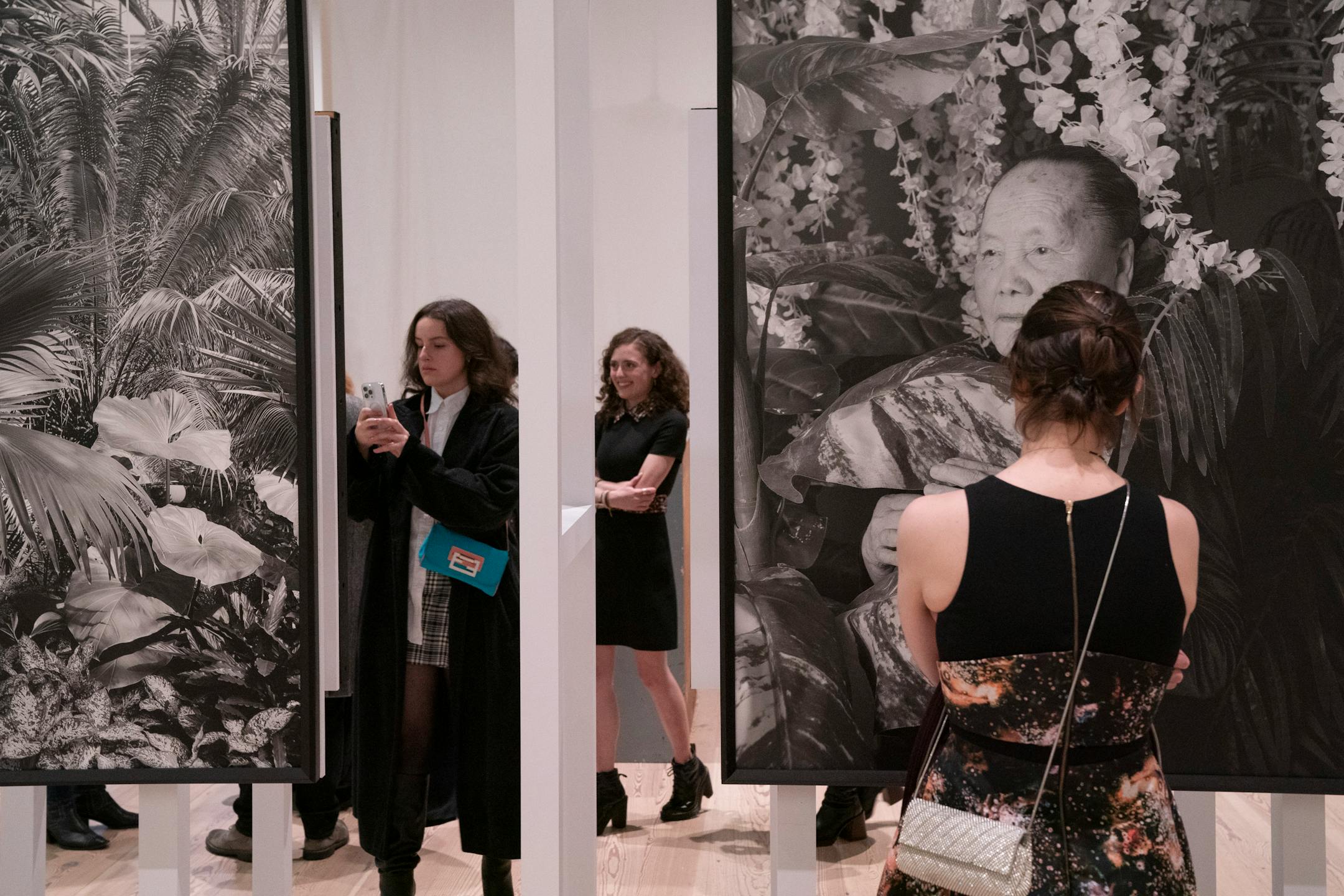 Visitors to the Whitney Museum contemplate photos by Pao Houa Her.