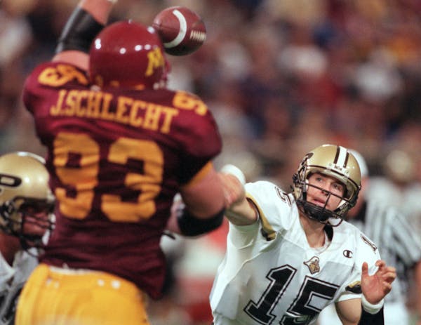 Gophers defensive tackle John Schlecht gets a hand on Purdue quarterback Drew Brees' third quarter pass in 1999.