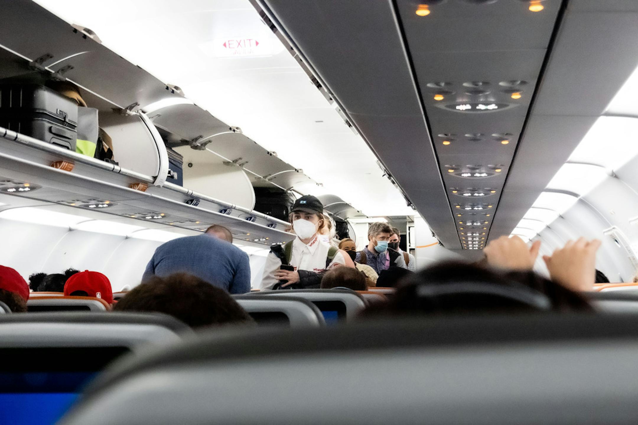 FILE — Travelers board a Jet Blue flight from Orlando International Airport in Orlando, Fla., to Washington Reagan Airport, on March 1, 2021. The Federal Aviation Administration said it had fielded 1,300 complaints of unruly passengers since February 2021, the same number of enforcement actions it took against passengers in the past decade. (Erin Schaff/The New York Times)