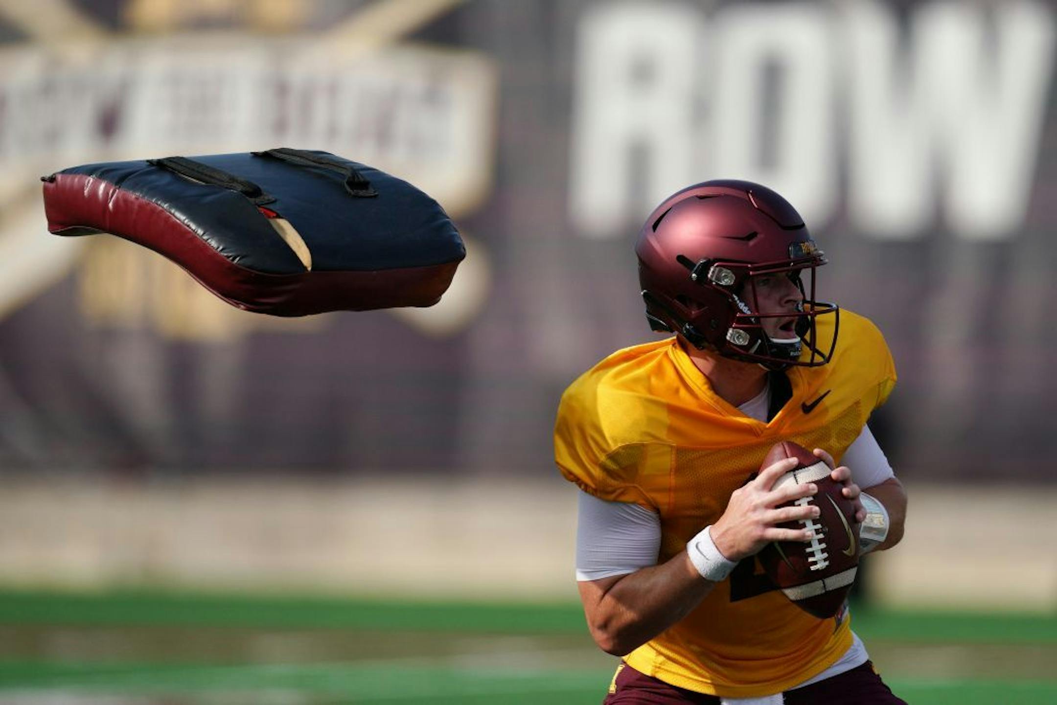 Minnesota Golden Gophers quarterback Tanner Morgan (2) dodged pads thrown at him during a drill at practice Friday.