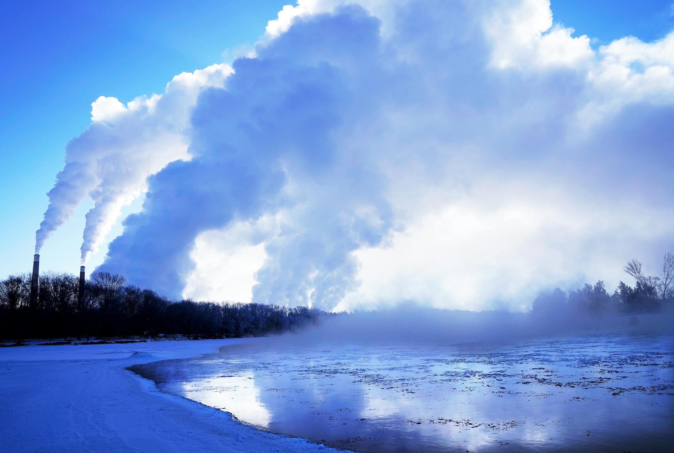 Steam from the Sherco Power Plant hangs over the frigid Mississippi River during subzero temps near Snuffy's Landing in Becker.