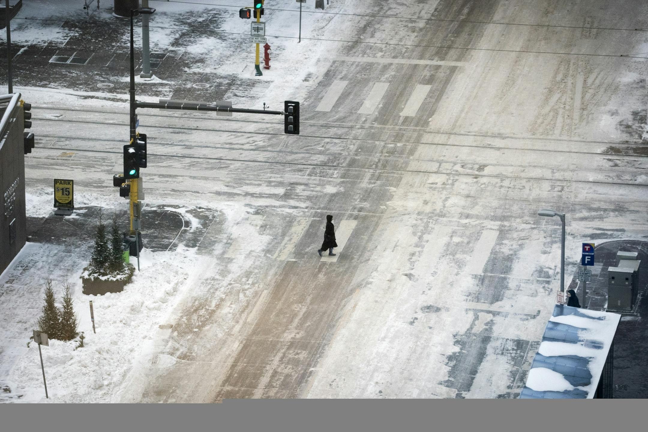 A pedestrian crossed 2nd Avenue at 6th Street in downtown Minneapolis on Tuesday night during what normally would be the evening rush hour.