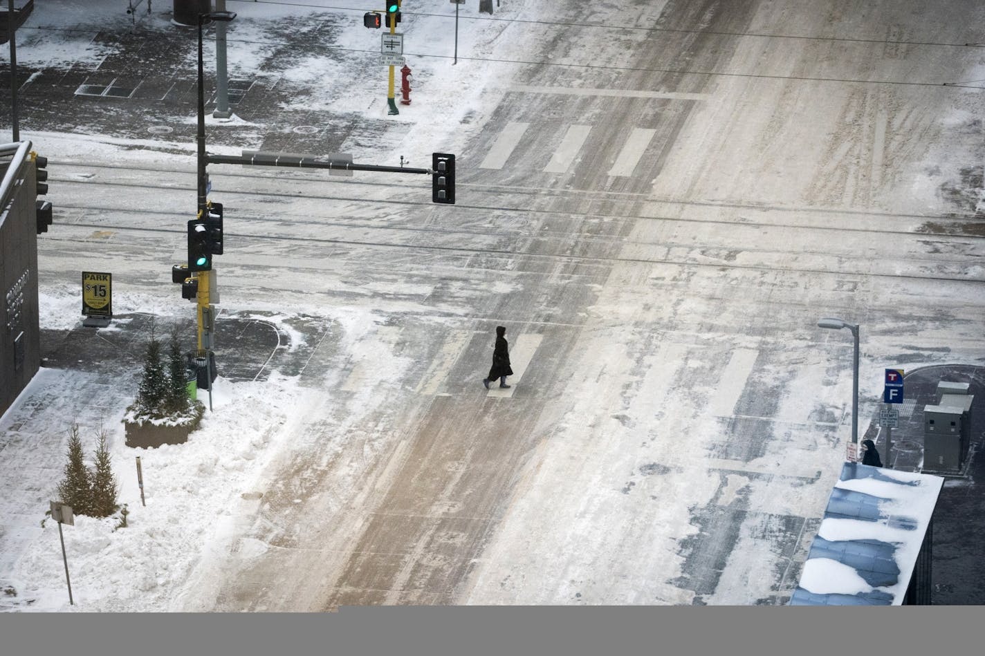 A pedestrian crossed 2nd Avenue at 6th Street in downtown Minneapolis on Tuesday night during what normally would be the evening rush hour.