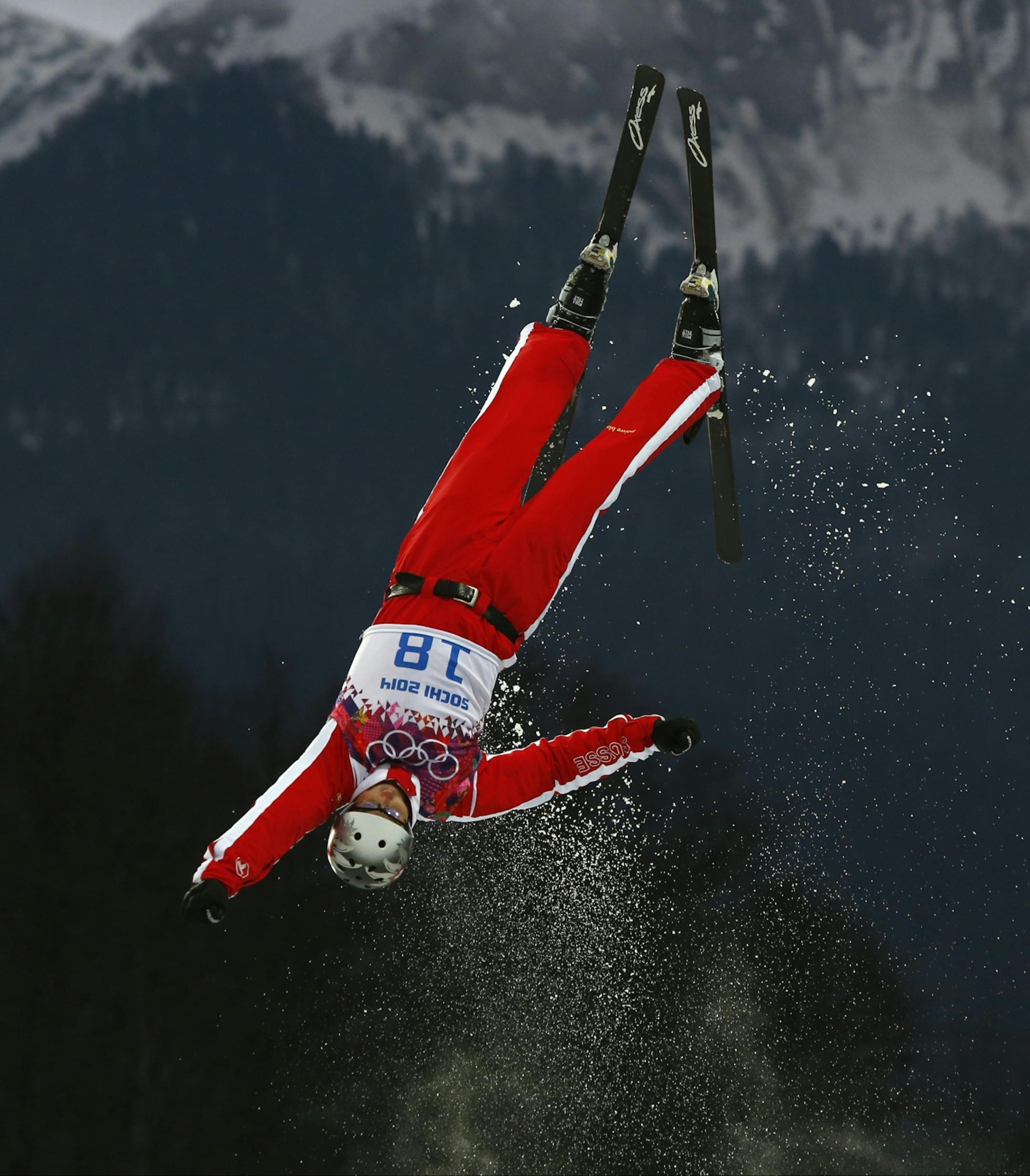 Switzerland's Thomas Lambert jumps during men's freestyle skiing aerials qualifying at the Rosa Khutor Extreme Park, at the 2014 Winter Olympics, Monday, Feb. 17, 2014, in Krasnaya Polyana, Russia.