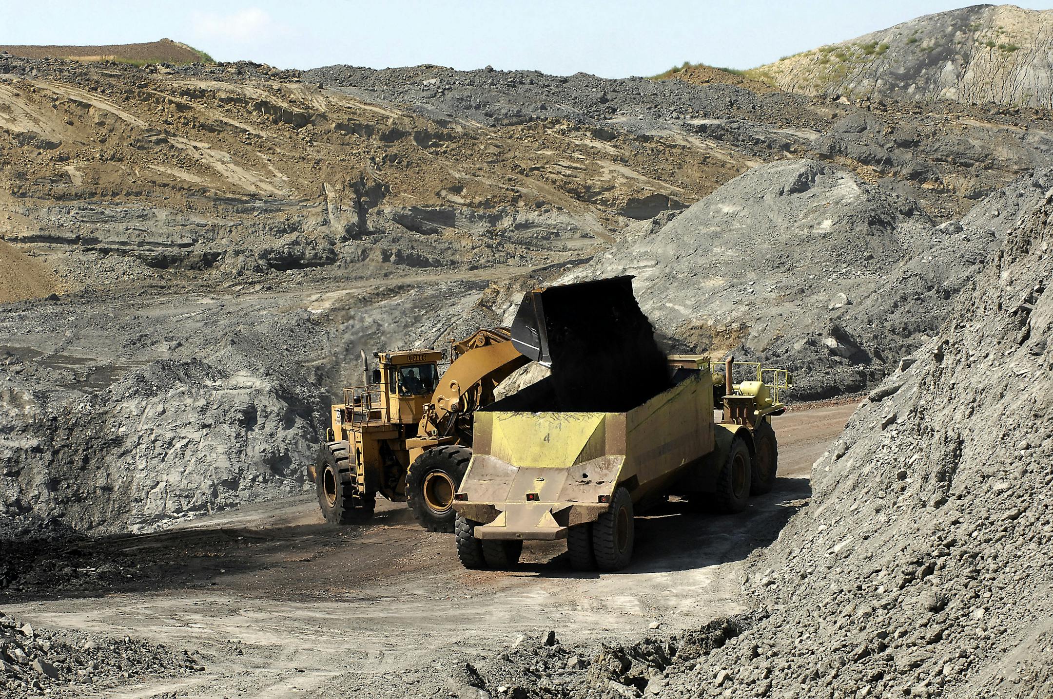 Surface mined coal is loaded into a truck at the Dakota Westmoreland Corp coal mine in Beulah, N.D.