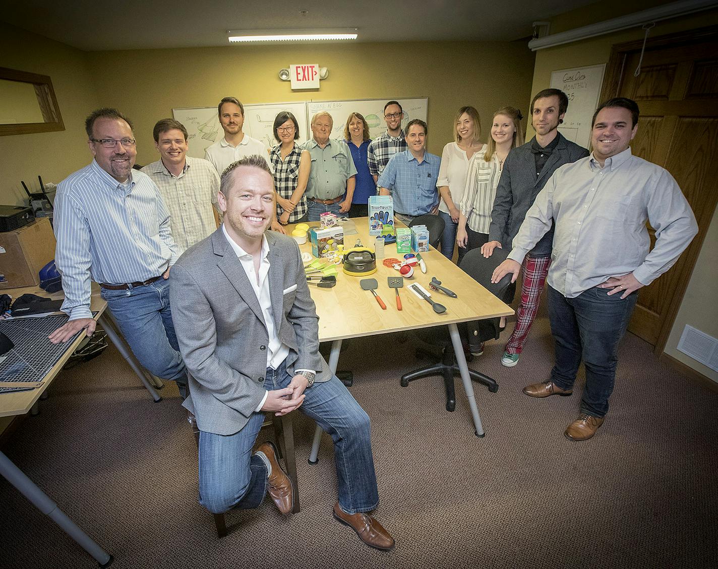 Local entrepreneur Trevor Lambert with the staff at Enhance Product Development, which walks clients through all the steps of curating an invention idea.