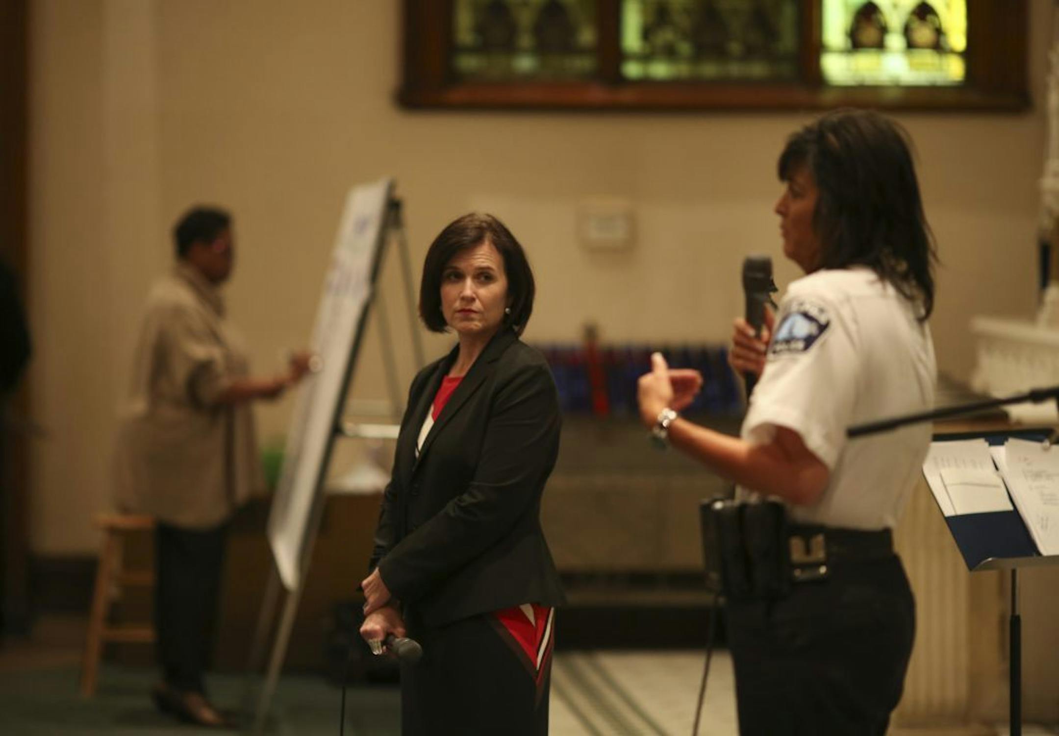 Mayor Betsy Hodges listened as Police Chief Janee Harteau responded to a question from an audience member Monday night.