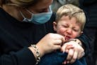 Sarah Glick, helped her son Harrison, 3, by swabbing his nose while getting tested for COVID-19 in Pittsburgh on Tuesday. She said they were getting t