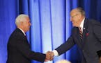 Republican vice presidential candidate, Indiana Gov. Mike Pence, left, shakes hands with former New York Mayor Rudy Giuliani, before Republican Presid