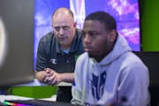T-Wolves Gaming coach Justin Butler watched his team scrimmage with the Philadelphia 76ers' e-sports team.