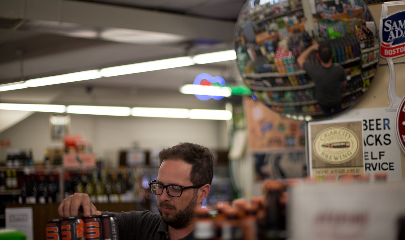 Andy Olson, a Sharrett's employee, re-arranges a beer display in the store. ] ALEX KORMANN &#x2022; alex.kormann@startribune.com It has been a year since Minnesota began to allow the sale of alcohol on Sunday. Most liquor stores operate on limited hours on Sunday. Sharrett's Liquor Store on University Ave is open 11AM-4PM on Sundays. The employees say being open on Sunday comes in handy every so often. When there's a slow Saturday it helps the store to make up for sales and turn a profitable wee