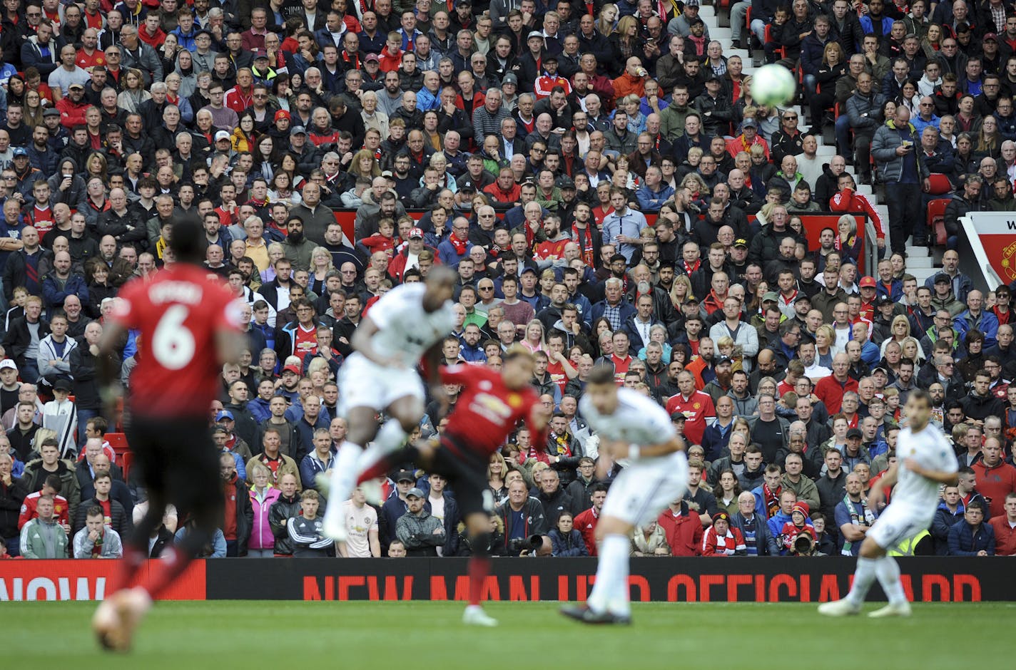 Manchester United fans watch the English Premier League soccer match on Sept. 22 between Manchester United and Wolverhampton Wanderers at Old Trafford stadium in Manchester, England.