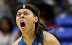 Minnesota Lynx's Seimone Augustus (33) celebrates after sinking a basket late in the second half of a WNBA basketball game against the Dallas Wings on