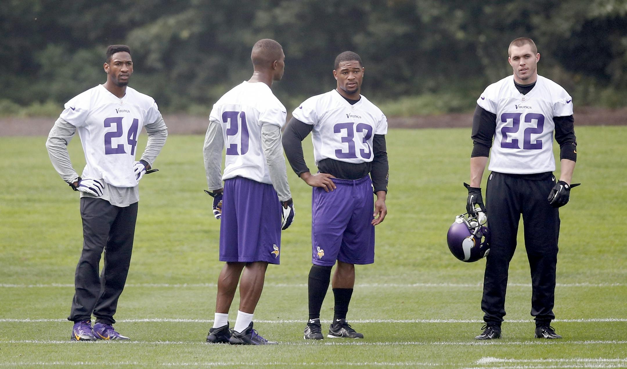 Minnesota Vikings A.J. Jefferson (24), Chris Cook (21), Jamarca Sanford (33) and Harrison Smith (22) during practice on Wednesday at The Grove in Watford, England. Jefferson, Cook, Sanford did not participate in team drills.