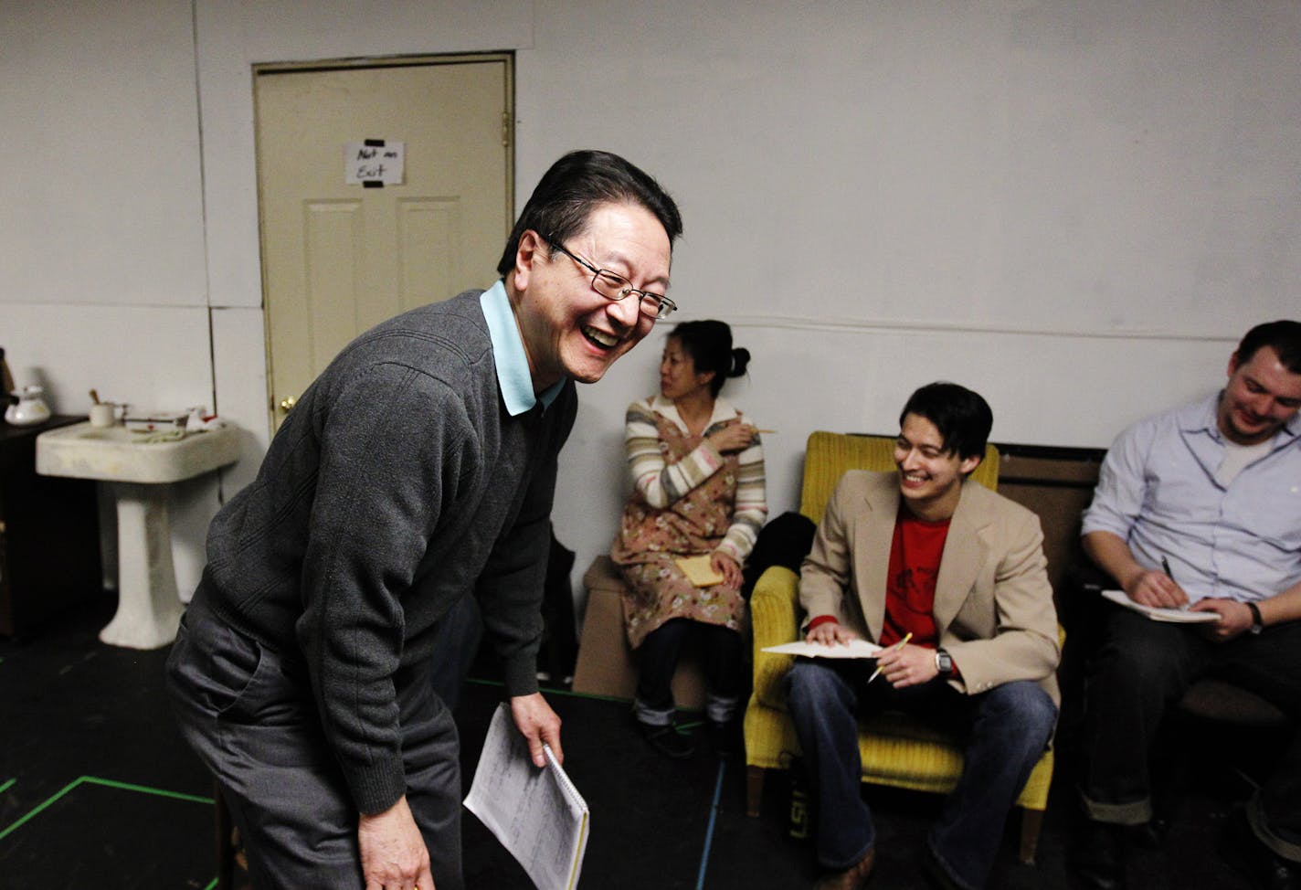 Rick Shiomi, writer and director of the play "Yellow Fever", shares a laugh with the cast during the production's rehearsal at Mu Performing Arts Friday, March 1, 2013 in Minneapolis. The play launched the career of Shiomi and marks his final production as Mu's artistic director. (Genevieve Ross/Special to the Star Tribune)