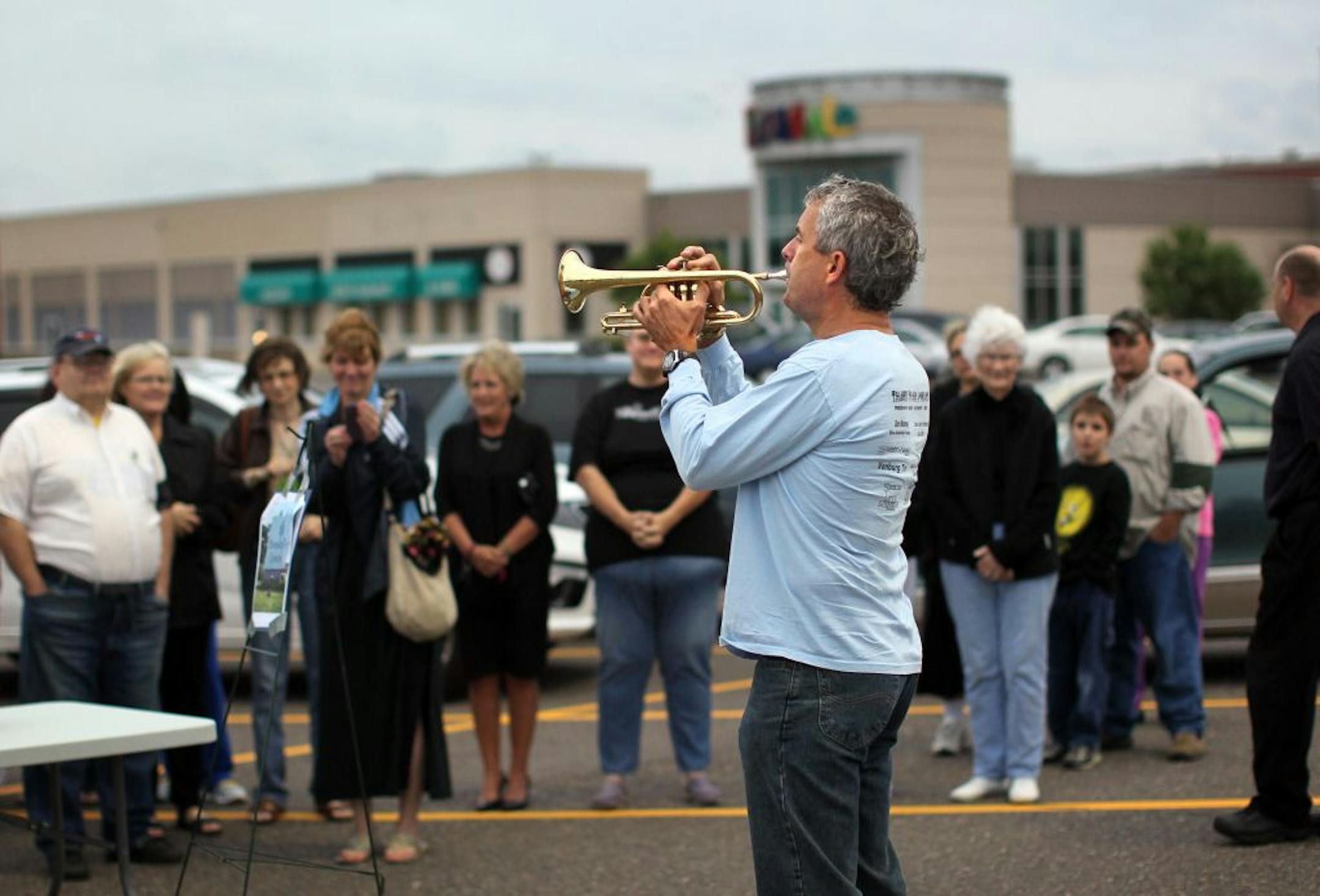 Kevin Slator sounded taps at a farewell "funeral" for Brookdale Mall in Brooklyn Center. Holly Harwig organized the event mostly to reunite friends to reminisce.