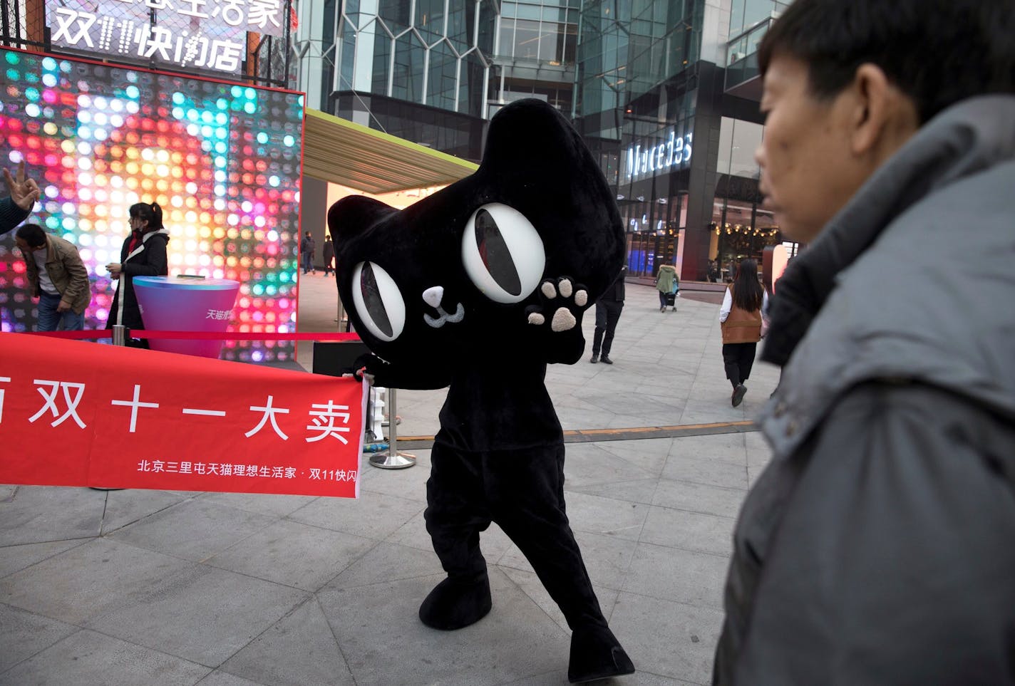 A mascot for Tmall, an online shopping website owned by Alibaba, holds up a banner with the word "Double 11 big sale" during an event to promote Singles Day in Beijing, China, Monday, Nov. 6, 2017. On Nov 11, online shoppers are expected to spend billions of dollars on "Singles' Day," a quirky holiday that has grown into the world's busiest day for e-commerce. (AP Photo/Ng Han Guan) ORG XMIT: XHG103